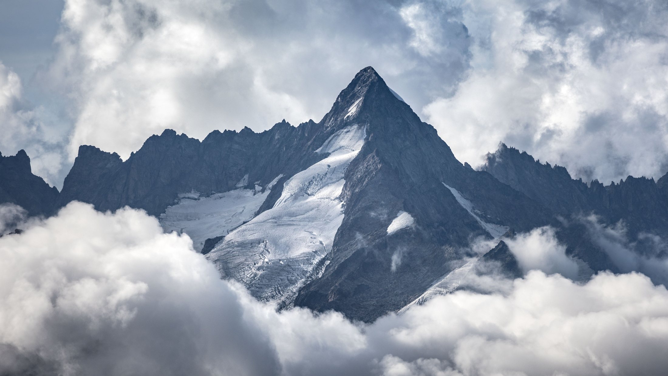 Un pico de montaña emergiendo entre las nubes